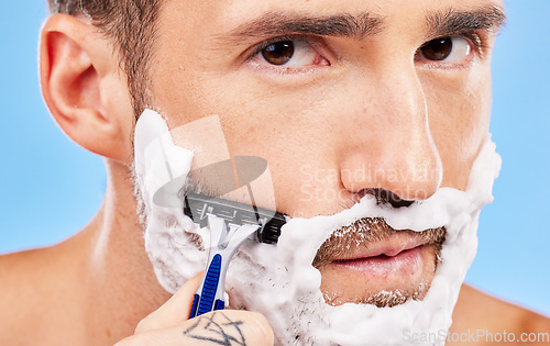 Image of Shaving face, hair removal and man with razor in grooming and hygiene portrait, cream on beard to clean and beauty with studio background. Foam, moisturizer and cleaning with skincare and wellness.