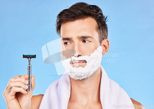 Image of Man doubt, shave and face in studio with razor, thinking or cosmetics for self care, beauty and foam. Grooming, facial health and skincare with shaving cream, beard and contemplating in bathroom