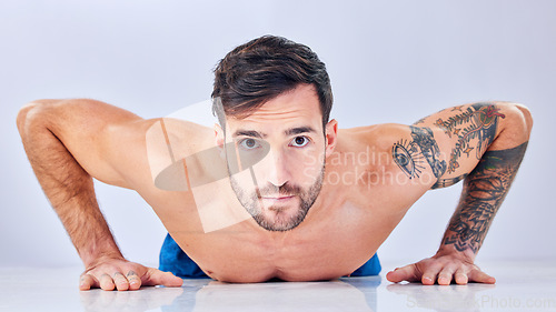 Image of Portrait, man and push up on studio floor for fitness, cardio workout or strong muscle development. Young bodybuilder, training and exercise for motivation wellness health or natural happy lifestyle