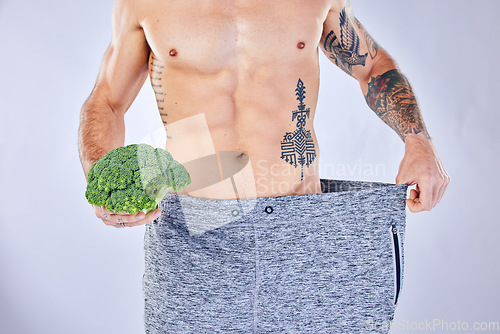 Image of Vegetable, diet and weight loss, man on health detox and workout exercise for healthy lifestyle on studio background. Fitness, nutrition and wellness for balance in body, male model with tattoo.