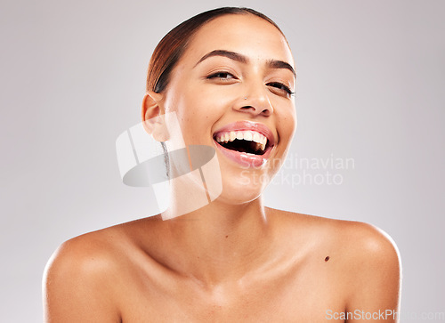 Image of Portrait, cosmetics and young woman with skincare, with natural beauty, confident and smile on grey studio background. Makeup, girl or female with body care, wellness or organic facial for skin detox