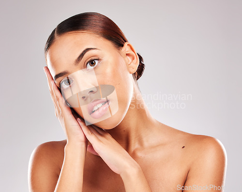 Image of Face portrait, beauty skincare and woman in studio on a gray background. Luxury makeup, aesthetics and young female model posing with hands for cosmetics, healthy natural skin and facial wellness.