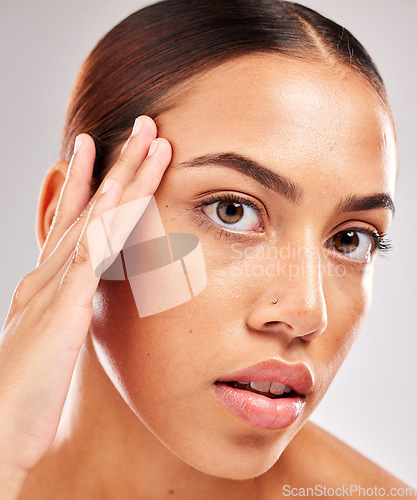 Image of Skincare, health and headshot portrait of a woman with a wellness, natural and face routine in a studio. Beauty, cosmetics and girl model from Brazil with healthy skin isolated by a gray background.