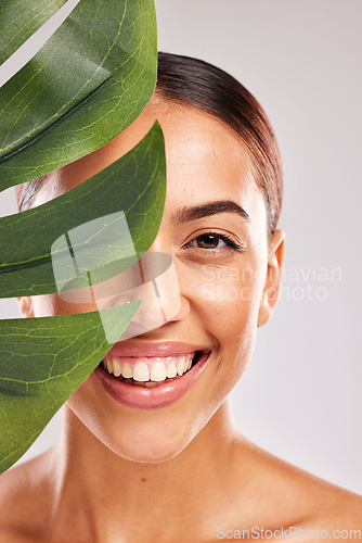 Image of Leaf, woman and beauty, natural skincare and clean cosmetics for wellness, glow and sustainability on studio background. Portrait of happy model face, green monstera leaves and eco plants dermatology