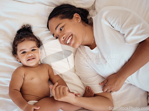 Image of Top view, mama and baby with smile, on bed and happy together for bonding, childhood and loving in home. Love, mom or toddler in bedroom, happiness or positive for wellness, tenderness and motherhood