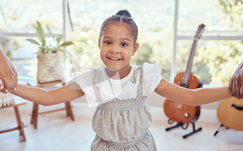 Image of Girl in living room, portrait of kid holding hands for family support in child care or learning trust in Mexico home. Happy young kindergartener with smile on face, apartment lounge or kids happiness