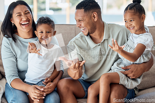 Image of Happy family, children or laughing and bonding on sofa in house or home living room in fun game, playful activity or superhero hands gesture. Smile, love or comic mother, father or parents with kids