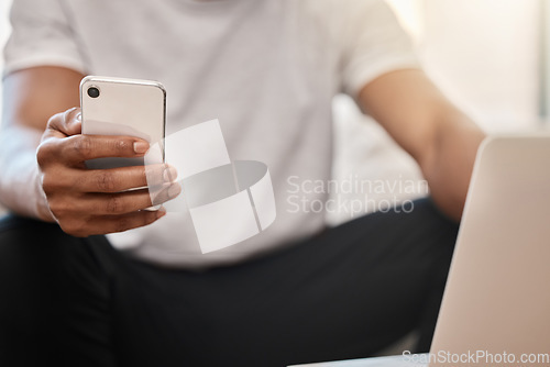 Image of Phone, communication and hands networking on social media, surfing the internet or searching for online content. Laptop, website and man texting, reading an email or posting on a social network app