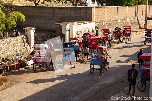 Image of Traditional rickshaw bicycle with Malagasy people on the street of Toliara, one of the ways to earn money. Everyday life on the street of Madagascar.