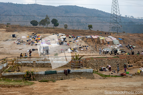 Image of Malagasy people dry their clothes on a rock in Akamasoa village. Traditional way of drying clothes in Africa.