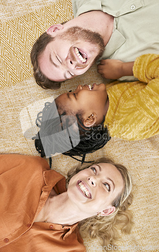 Image of Adoption and family with girl from above lying on floor, foster family together. Mom, dad and child lying on carpet playing, love and fun time in happy family home with trust and support.