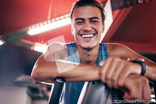 Image of Fitness, smile and portrait of man in gym, happiness in workout exercise with equipment in studio. Happy personal trainer or coach with smile on face, motivation and relax on break at sports training