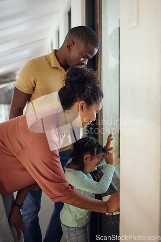 Image of Family, love and animal shelter with a girl, mother and father looking through a window together in a pet store. Charity, kids and community with a woman, man and daughter at an adoption center