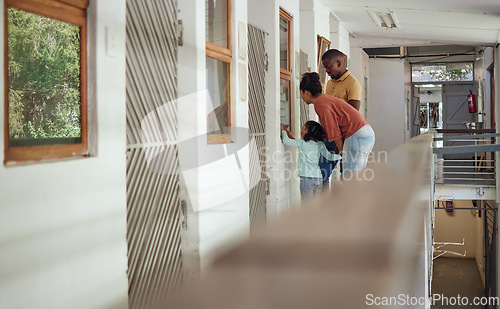 Image of Animal shelter, family and parents bonding with their child while doing community service together. Mother, father and kid looking through a window while volunteering at a pet center or adoption home