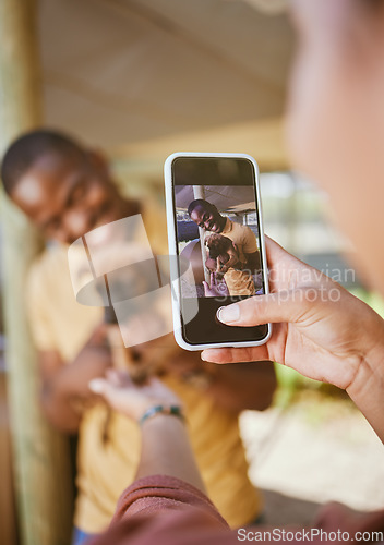 Image of Phone picture, dog and woman hand showing man and new pet outdoor with happiness. Black man, puppy and black woman together with couple bonding hug using mobile technology and camera with a smile