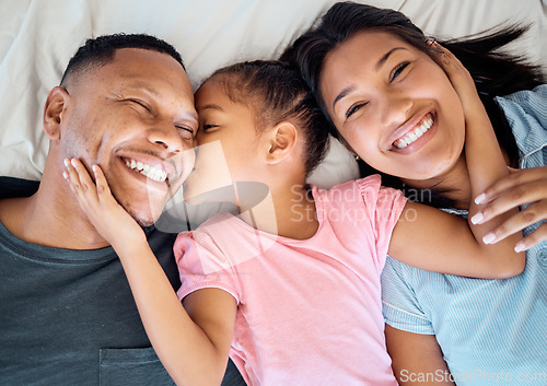Image of Top view, kiss and black family with girl on bed, smile and happy for bonding, loving and together. Portrait, love and mother with father, daughter and happiness to connect, in bedroom and embrace