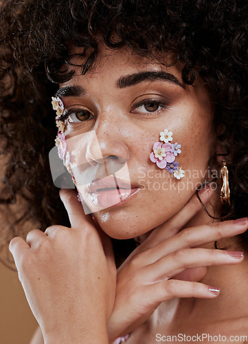 Image of Flowers, skincare and woman in studio for beauty, grooming and facial with product from nature, organic and eco friendly. Portrait, black woman and face of hair model with flower, plant and wellness