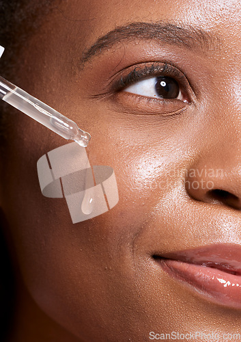 Image of Black woman, dropper and facial skincare cosmetics for beauty, hydration or oil treatment for healthy face. Closeup of African American female applying serum to cheek for skin hydrate, glow or shine