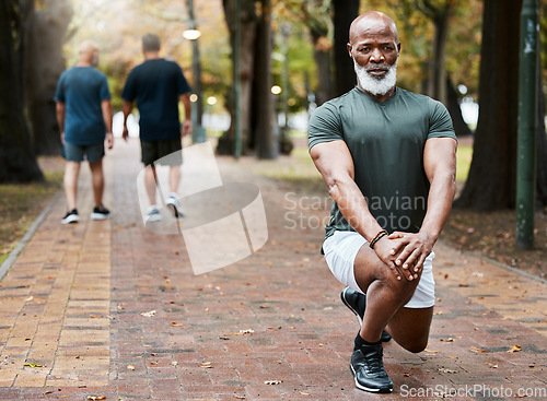 Image of Senior african man, stretching and park with focus for fitness, wellness and exercise on ground. Elderly black man, lunge and leg workout, training or muscle development in street for body health