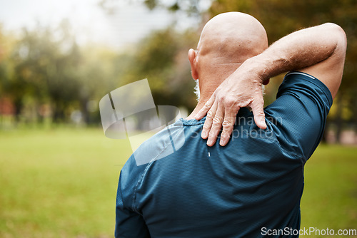 Image of Exercise, fitness and back pain of senior man at outdoor park after bad workout. Mature male runner with hand on spinal injury, fibromyalgia and muscle pain after cardio, running or training in natur