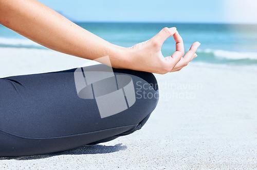 Image of Yoga, meditate and beach zen hand for chakra and wellness training by the ocean sand and sea. Woman in nature for mind health, exercise and breathing training in summer for mindfulness and balance