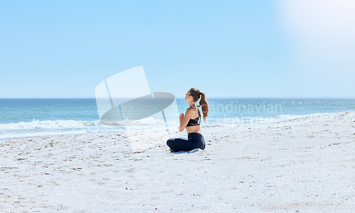 Image of Yoga, woman and outdoor at beach, on sand and meditation for wellness, relax and peace. Young female, healthy lady and calm for exercise, pilates and fitness for balance, seaside vacation and health.