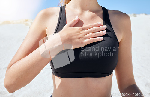 Image of Hand, chest and breathing with a sports woman on the beach during summer for health or wellness. Yoga, nature and fitness with a female athlete by the ocean or sea for exercise and mindfulness