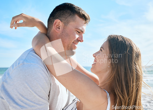 Image of Love, nature and couple hugging on beach, happy man and woman embrace at summer honeymoon destination. Travel, sea and happy couple relax and hug, spend time together on luxury vacation in Australia.