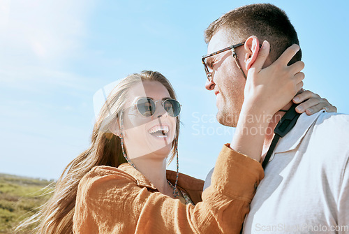 Image of Couple, travel and hug on a vacation adventure laughing on a walk outdoor in summer. Sunglasses, smile and love of a happy couple together with a funny, happiness and fun time in nature walking