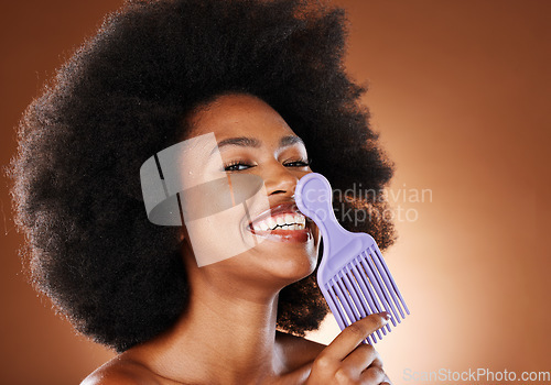 Image of Curly hair, beauty comb and black woman, afro style and cosmetics of hairsalon perm on studio background. Portrait happy african, brush and natural haircare treatment, fashion and big hairstyle