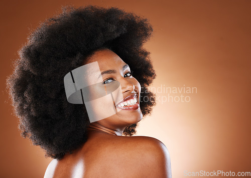 Image of Beauty, skincare and a happy black woman with a smile and afro looking back on studio background. Health, wellness and youth, a woman with body care, healthy glowing skin and happy grooming lifestyle