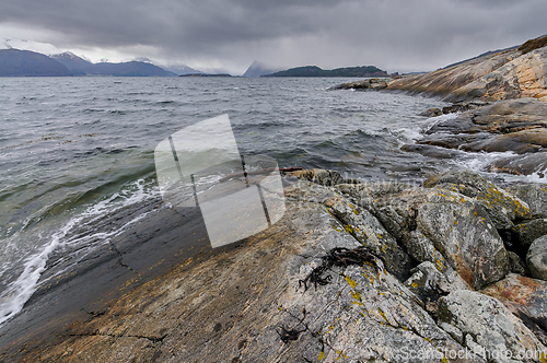 Image of rock formations on the coast with storm clouds