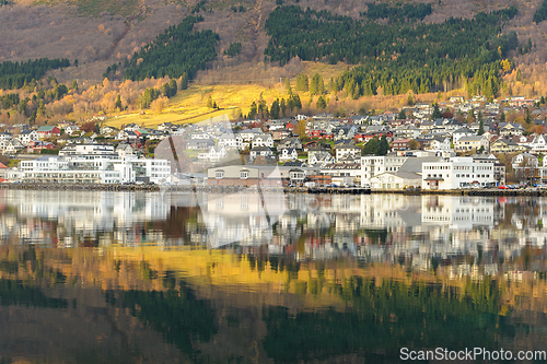 Image of small town mirrors in the sea with a streak of sun