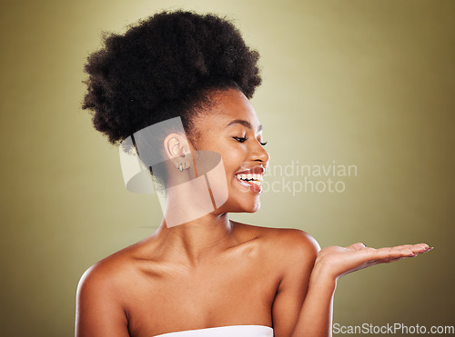 Image of Black woman, skincare and hand open gesture in studio while happy, healthy and smile with radiant glow on skin. Model, girl and palm with happiness, cosmetics and makeup for wellness against backdrop
