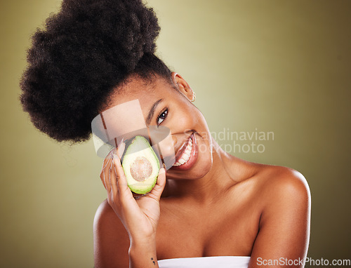 Image of Black woman, skincare and beauty in studio with avocado for health, nutrition or moisturizer for wellness. Woman, model and fruit for radiant glow skin, shine and healthy against cosmetics background