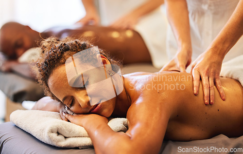 Image of Hands, massage and relax with a couple in a spa, lying on a table for wellness or luxury at a resort. Skin, bed and therapy with a man and woman in a beauty center for zen on holiday or vacation