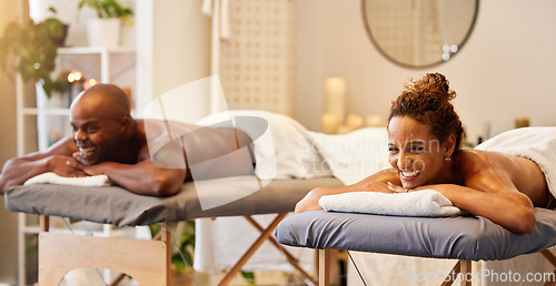 Image of Black couple, spa massage and happiness on a table for luxury, zen and relax together at a health and wellness salon. Man and woman enjoying hospitality, massage therapy and healthcare on vacation