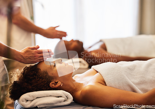 Image of Black couple, head massage and luxury spa to relax in a room for health, wellness and physical therapy. Man and woman on table for skincare, body care and hospitality while on a vacation