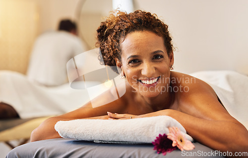 Image of Black woman, smile and relax in massage at spa for cosmetic skincare or beauty treatment at a resort. Portrait of African American female lying on massaging table or bed smiling for luxury wellness