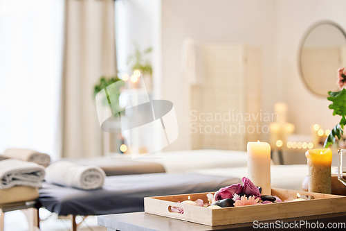 Image of Candle, spa and relax with aromatherapy treatment in a tray in a room for luxury or wellness. Background, health and massage with still life in an empty resort for peace, skincare or relaxation