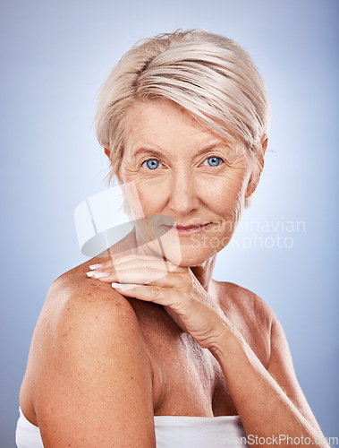 Image of Face, portrait and skincare with a senior woman in studio on a gray background for wellness or natural care. Beauty, antiaging and luxury with a mature female posing to promote skin or bodycare