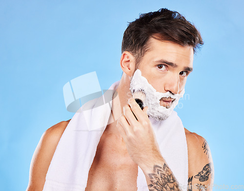 Image of Man, shave and face cream for beauty grooming or skincare health in studio. Shaving, facial cosmetics healthcare and hair removal facial morning routine with brush for hygiene against blue background