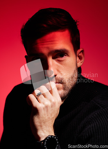 Image of Man, ideas and thinking headshot on red background, color and dark shadow, vintage lighting and luxury fashion accessories in studio. Young male model face, neon spotlight and creative retro backdrop