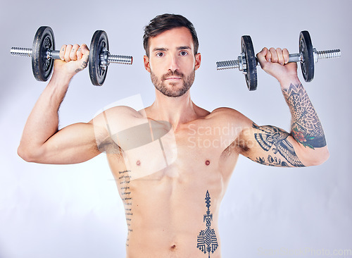 Image of Portrait, exercise and man with weights for training, fitness and workout with grey studio background. Weightlifting, bodybuilder and healthy male with equipment for wellness, progress and body care.