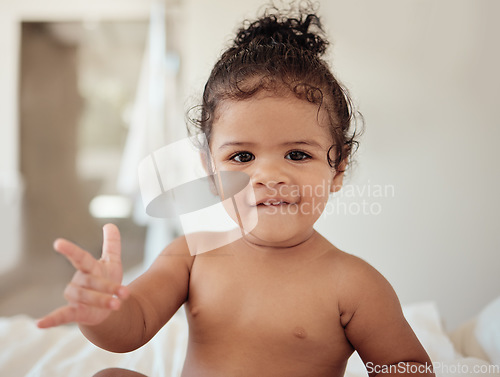 Image of Baby, rock and roll hand sign, portrait in bed, morning and happy, cool kid with rocker expression in house. Girl child play in bedroom, smile and have fun while relax, cute and sitting in home