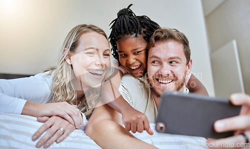 Image of Family, selfie and happiness on bed for social media profile picture or post about adoption, love and support of parents for foster child. Man, woman and girl together in bedroom with smartphone