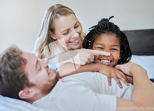 Image of Black girl, child or parents bonding on bed in house, home or hotel in fun game or activity. Smile, happy or laughing kid with mother, father with foster or interracial family in relax bedroom