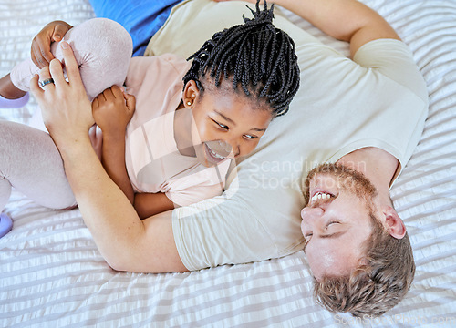 Image of Adoption, play and father with girl on the bed in the morning with a smile for happy in their family home. Family, love and dad playing with his child in a bedroom, love and laugh in a house together