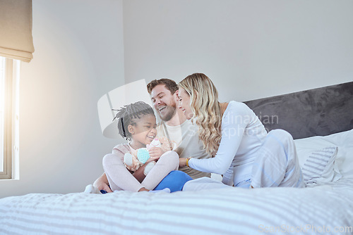 Image of Interracial, adoption family and bed with smile, happiness and bonding together with kid, home and love. Diversity, happy family and sitting in bedroom with child, african girl and parents in house