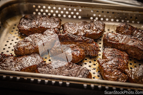 Image of Pieces of grilled steak with fat